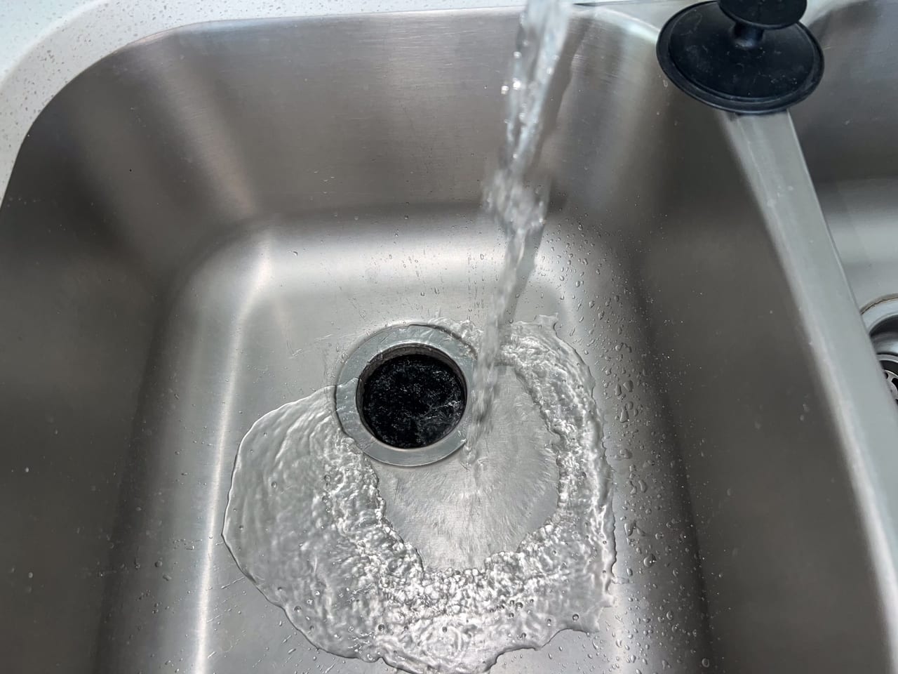 Sink basin, flowing water and drain opening